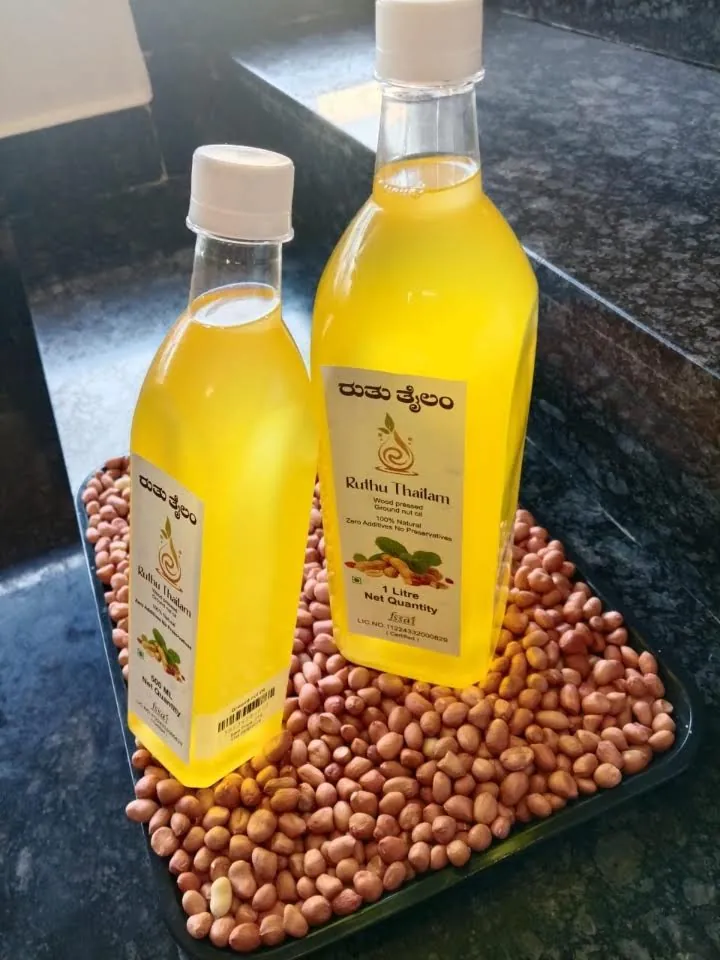 Groundnut oil, 1 litre and 500 ml bottles on groundnuts
