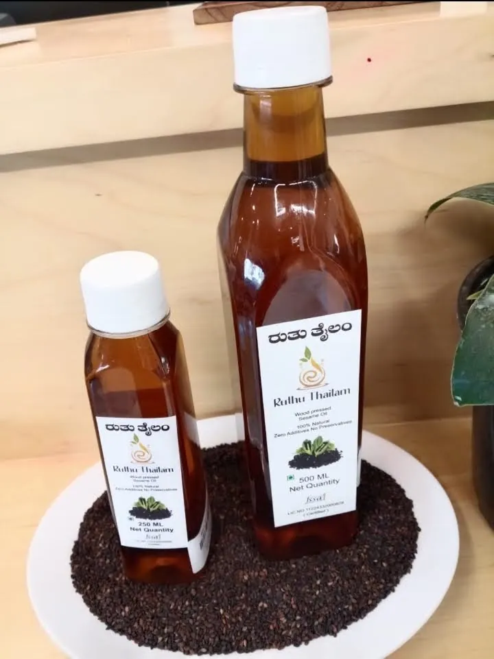 Wood-pressed sesame oil, 500 ml and 250 ml bottles on black sesame